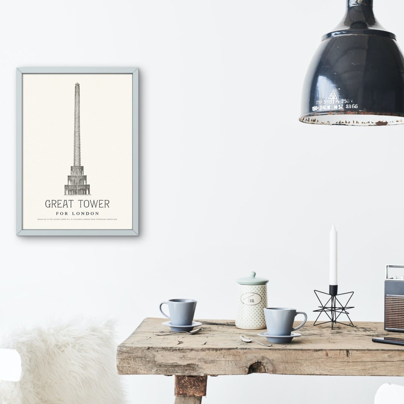 Cozy dining area with framed tower illustration.