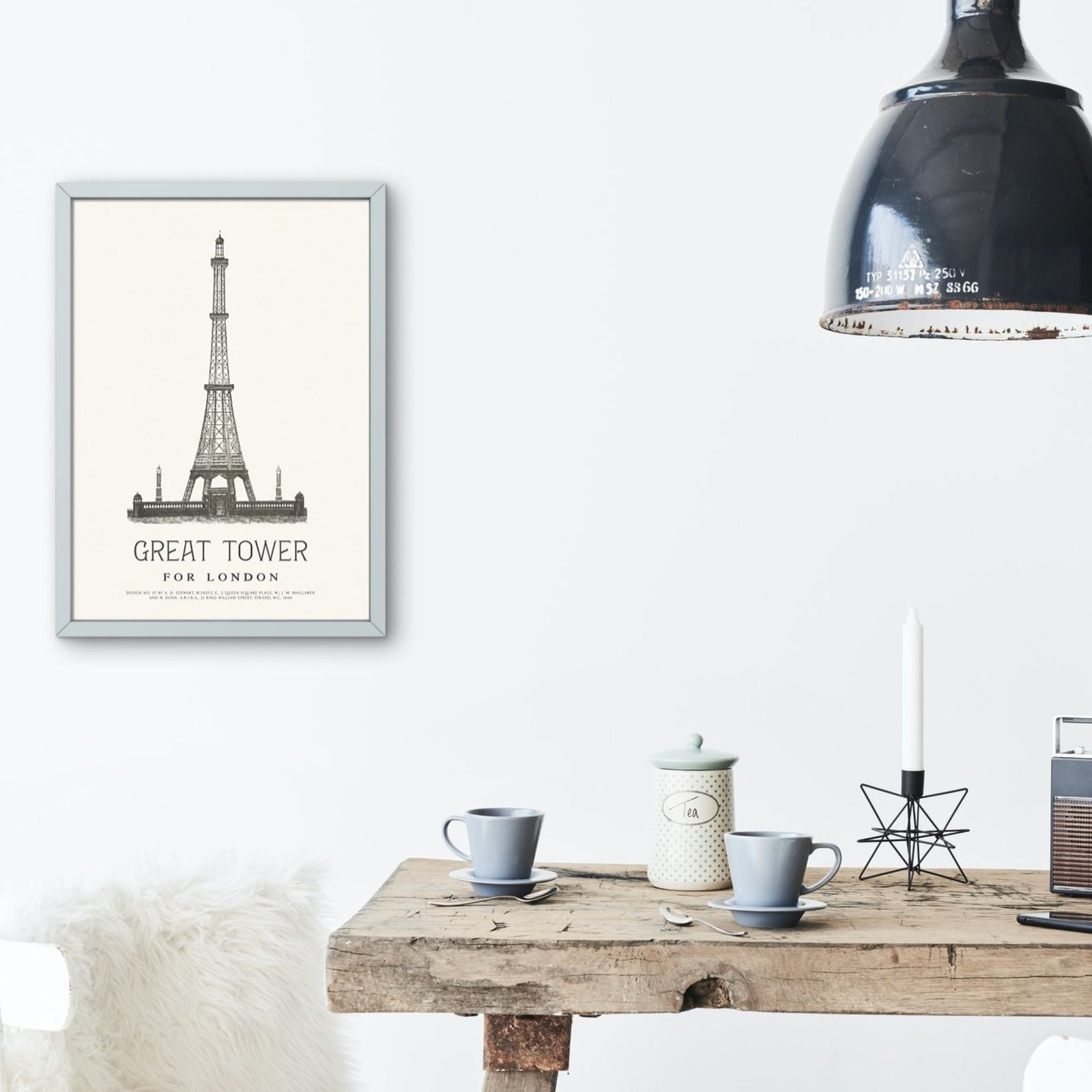 Eiffel Tower print above rustic table with cups.
