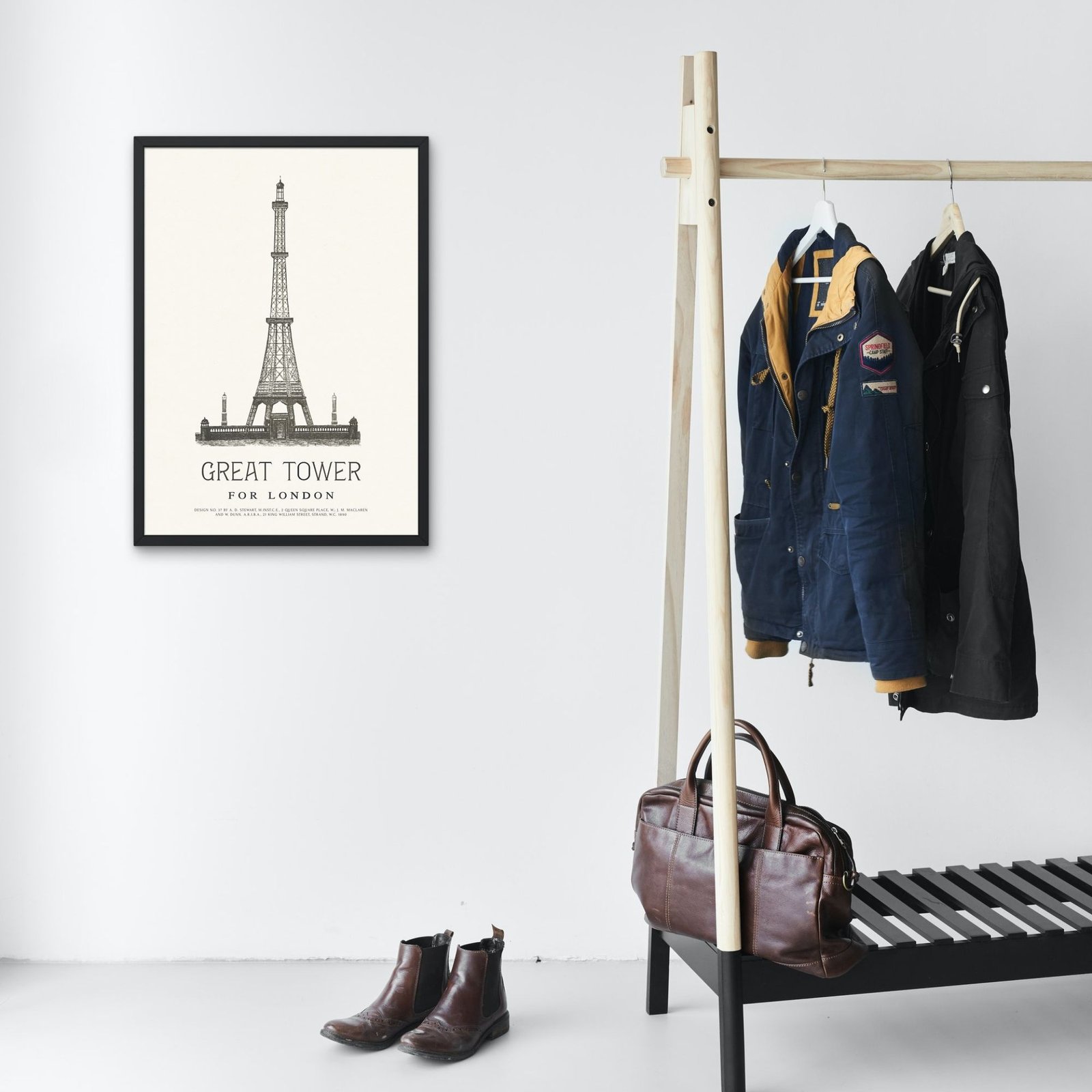 Cozy entryway with framed tower poster and jackets.
