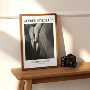 Framed Alfred Stieglitz photograph beside vintage camera