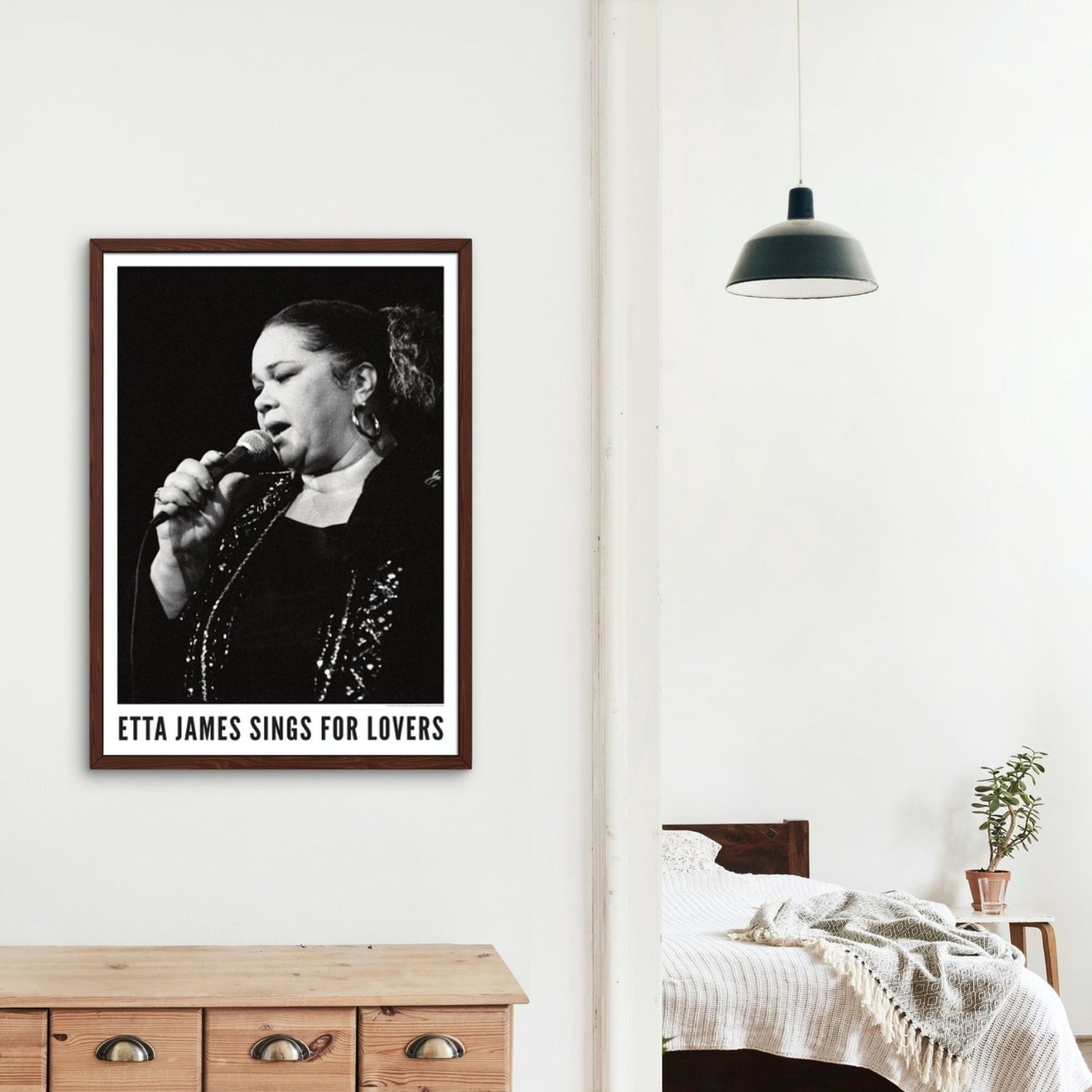 Framed Etta James poster in a cozy bedroom.