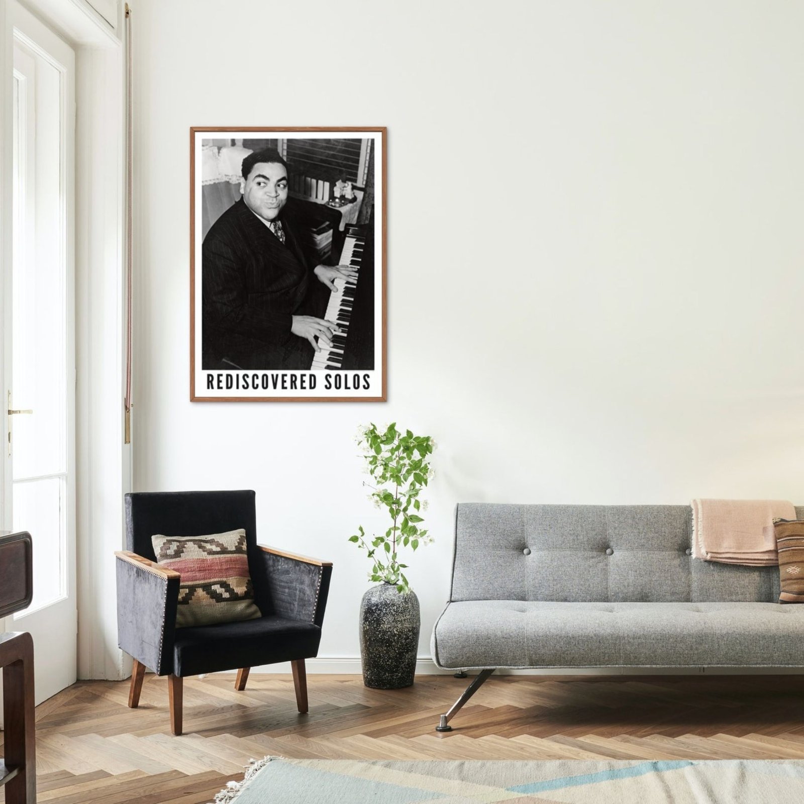 Living room with Rediscovered Solos poster on wall.