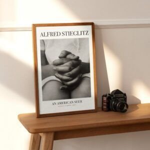 Framed photograph and camera on wooden shelf.