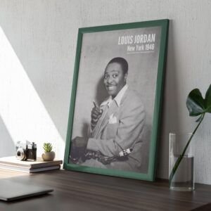 Framed black-and-white portrait on wooden desk.