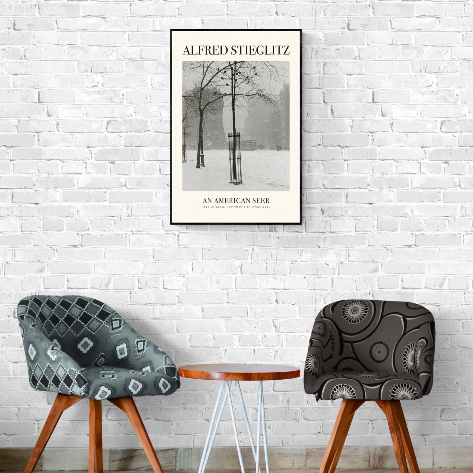 Chairs and table below framed Alfred Stieglitz poster.
