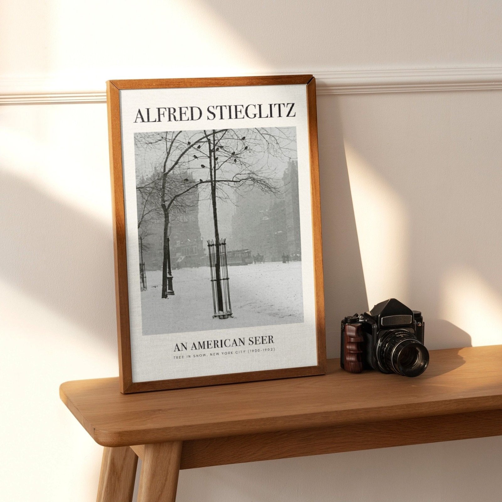 Framed photo of snowy trees on wooden shelf.
