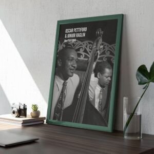 Framed photo of two jazz musicians on a desk.
