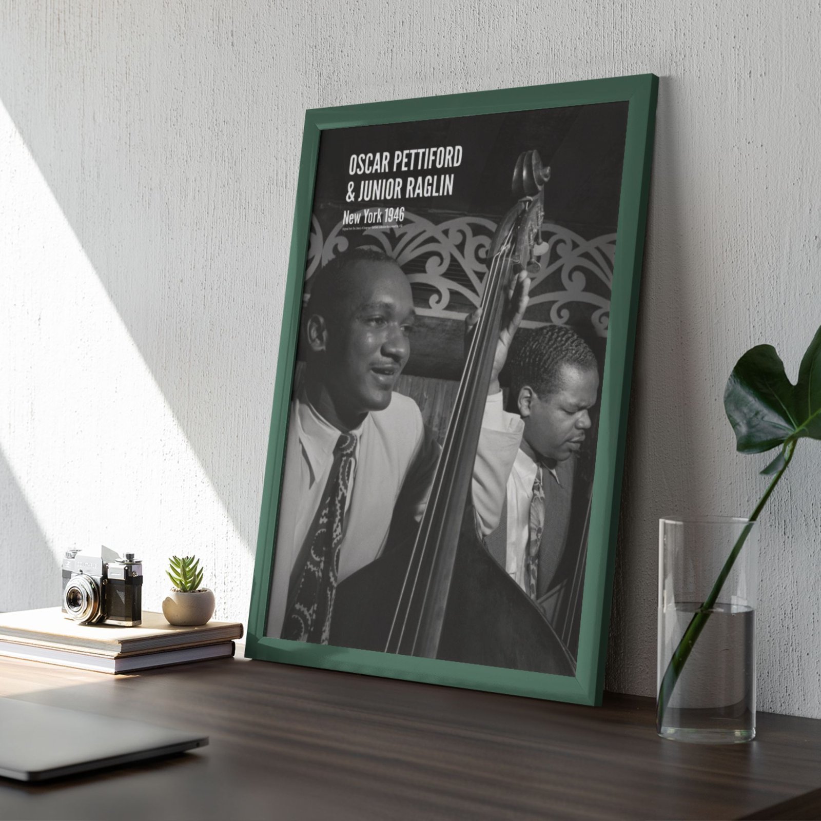 Framed photo of two jazz musicians on a desk.
