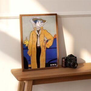 Framed fashion illustration beside vintage camera on table.
