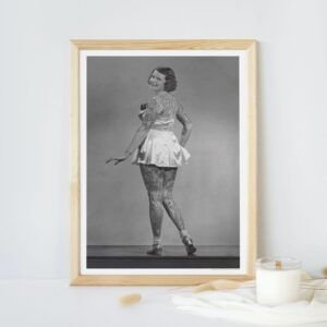Vintage photo of tattooed woman in framed portrait.