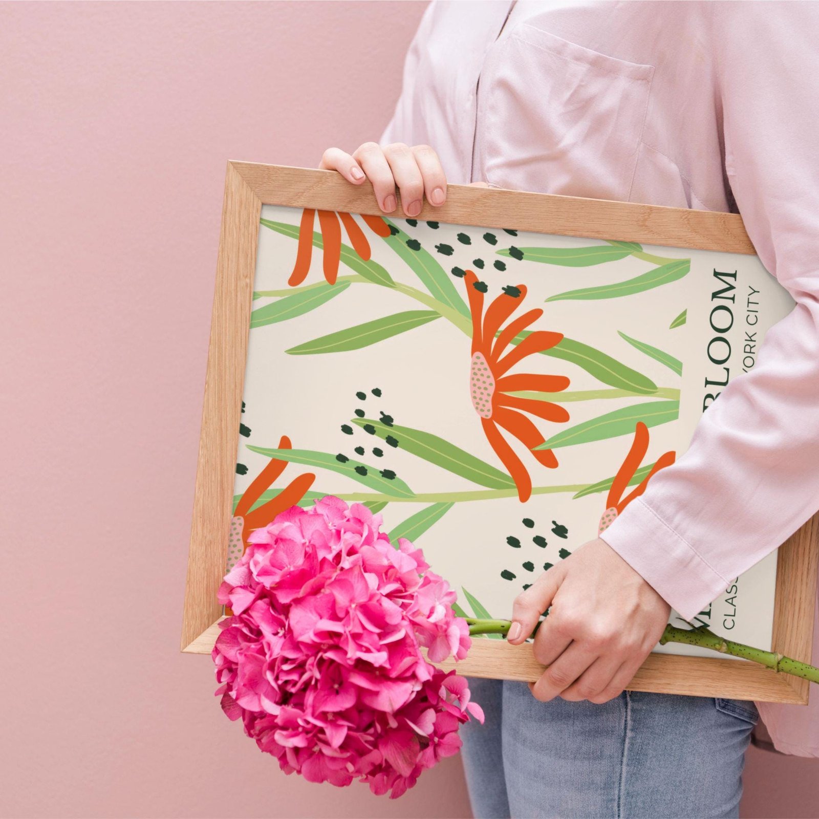 Person holding floral artwork with pink flowers