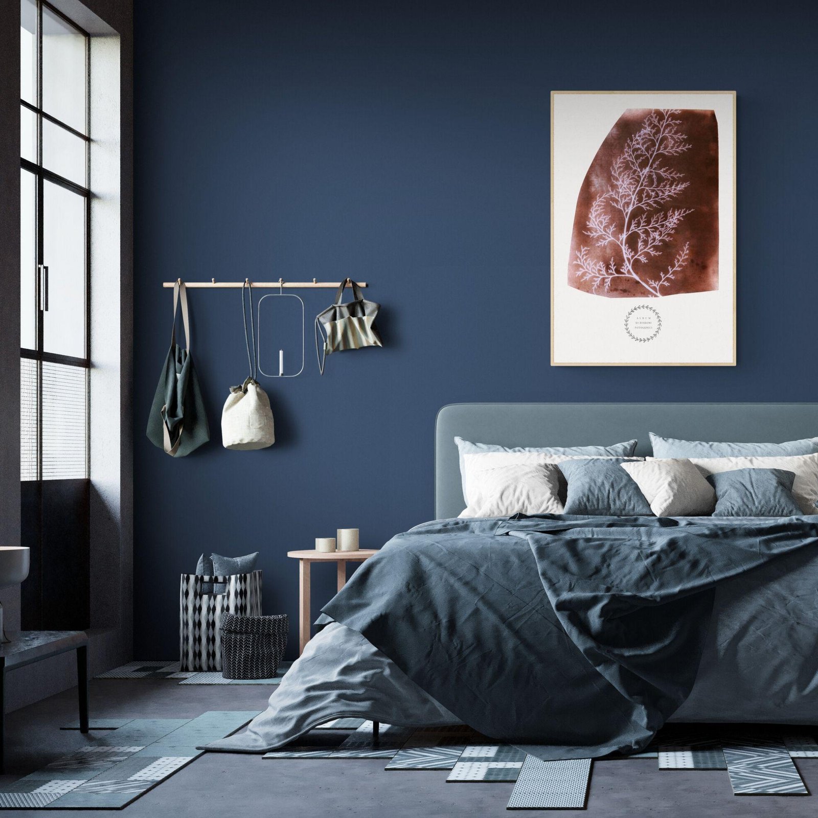 Modern bedroom with blue walls and hanging artwork.
