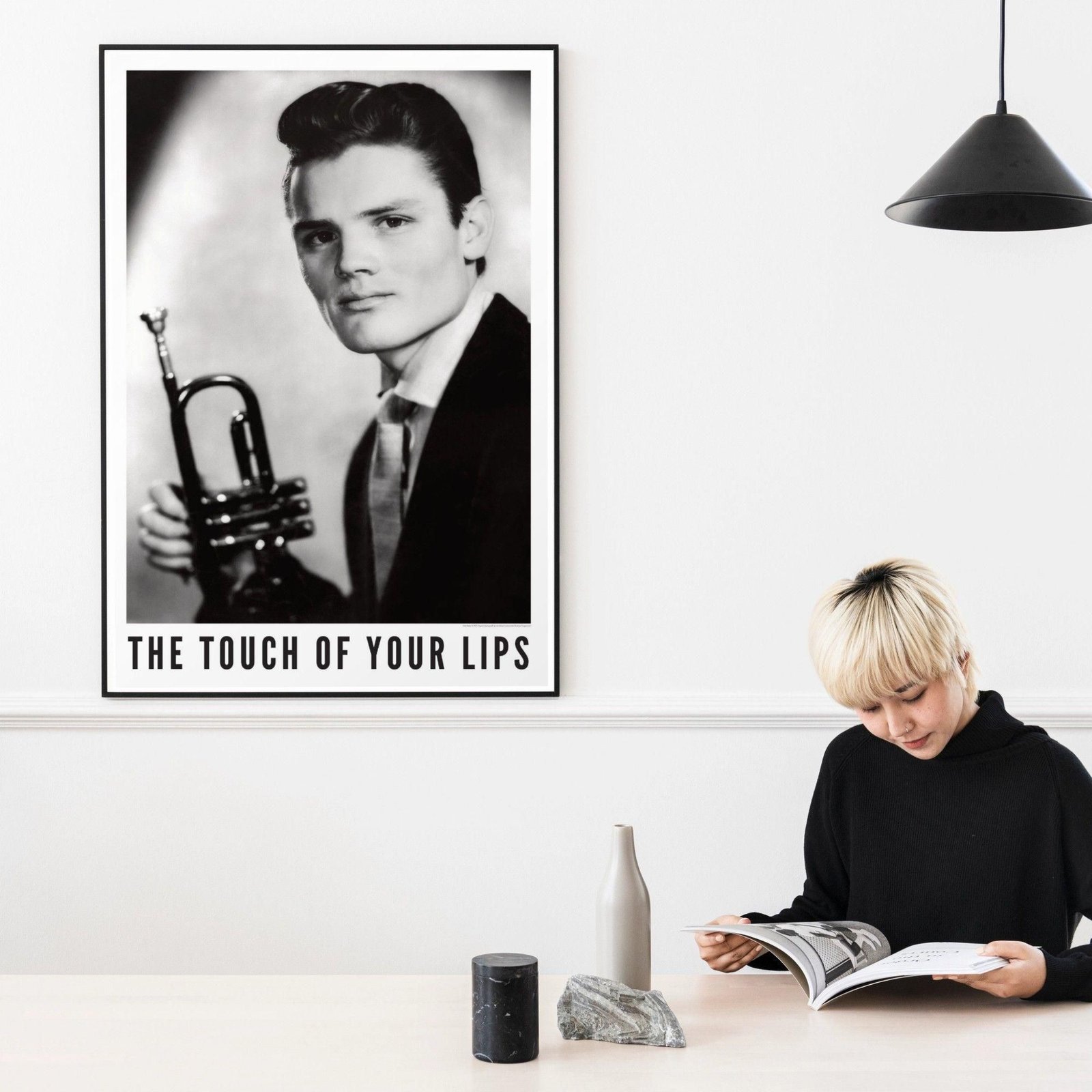 Person reading near trumpet photo poster.