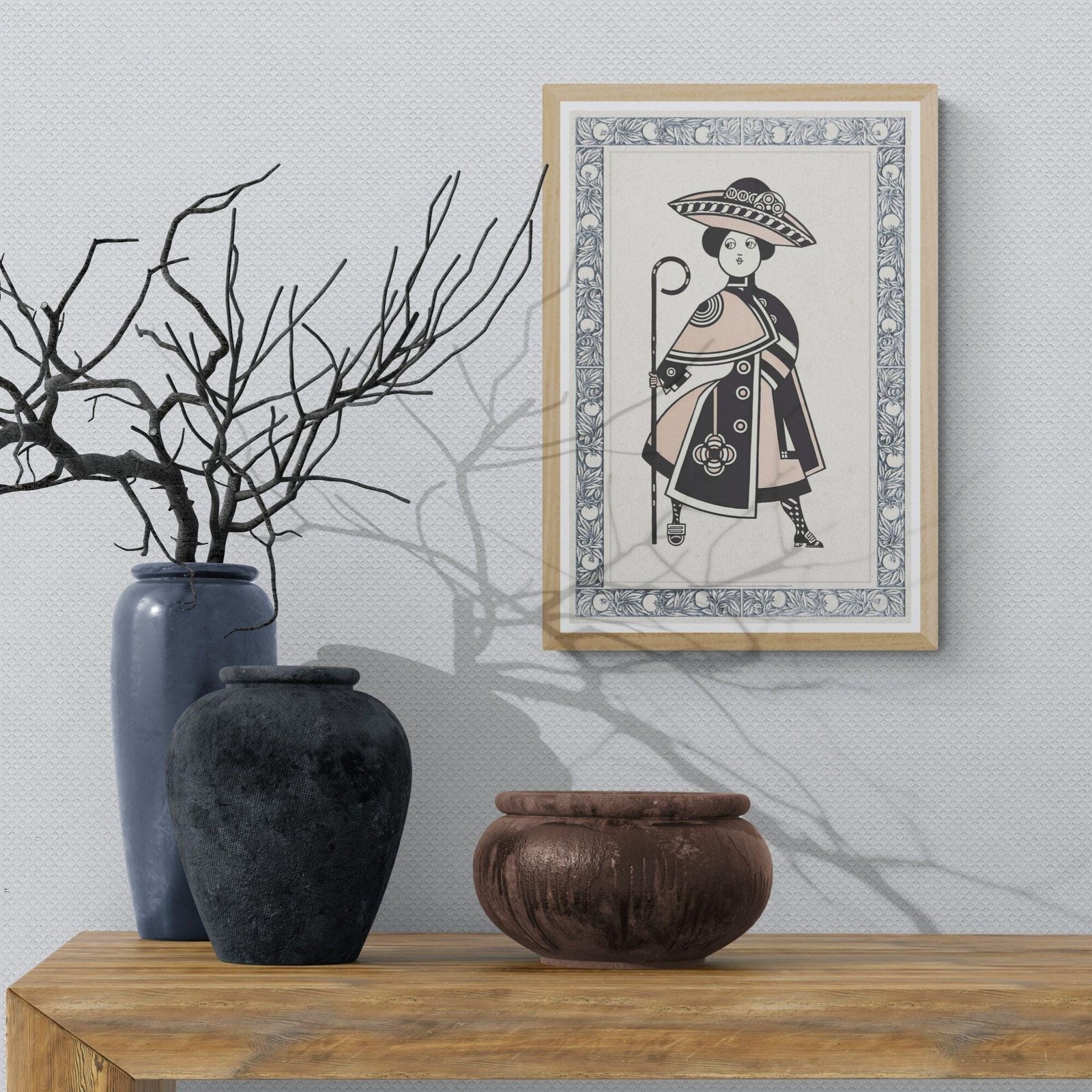 Framed artwork with vases on wooden shelf.