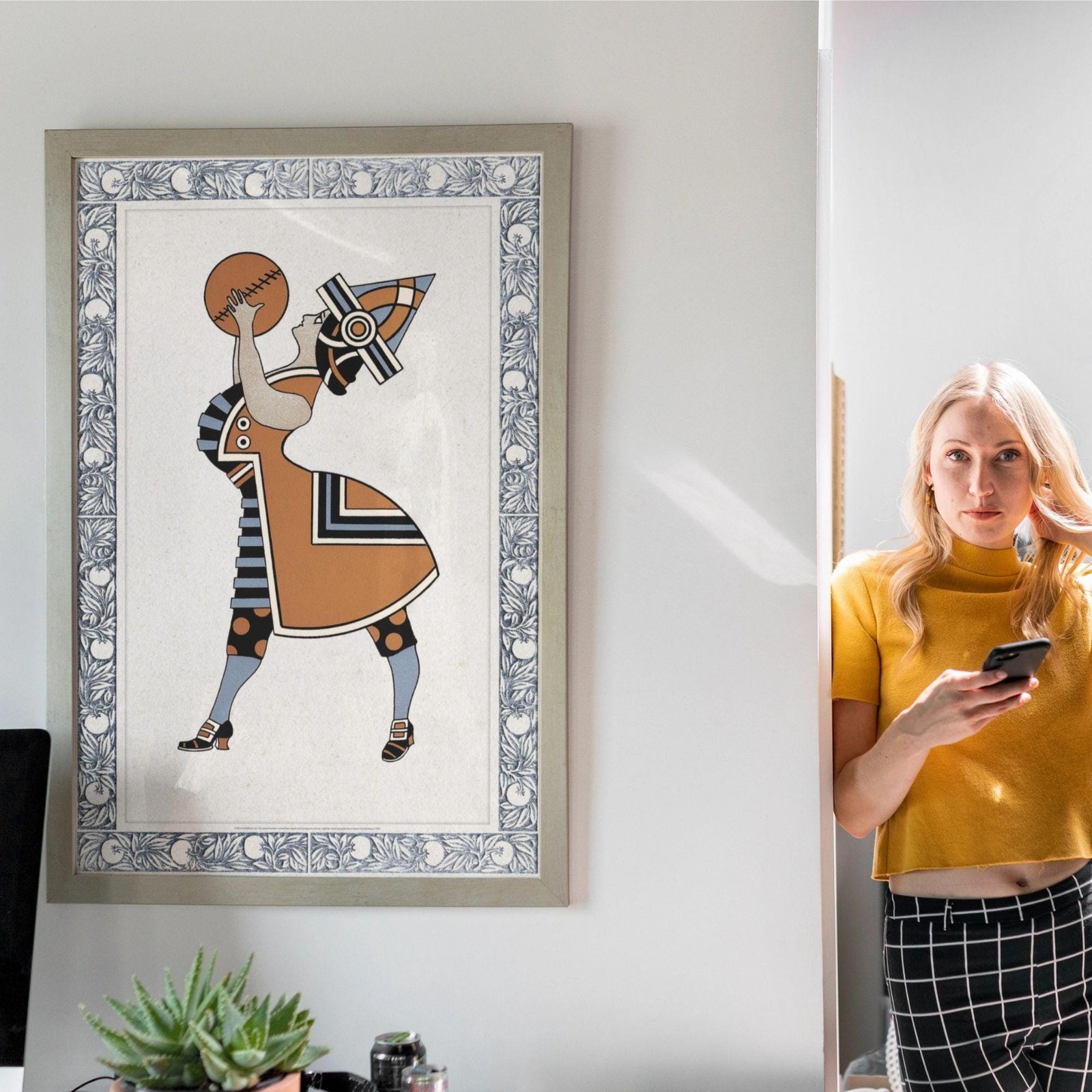 Woman in yellow near art deco basketball poster.
