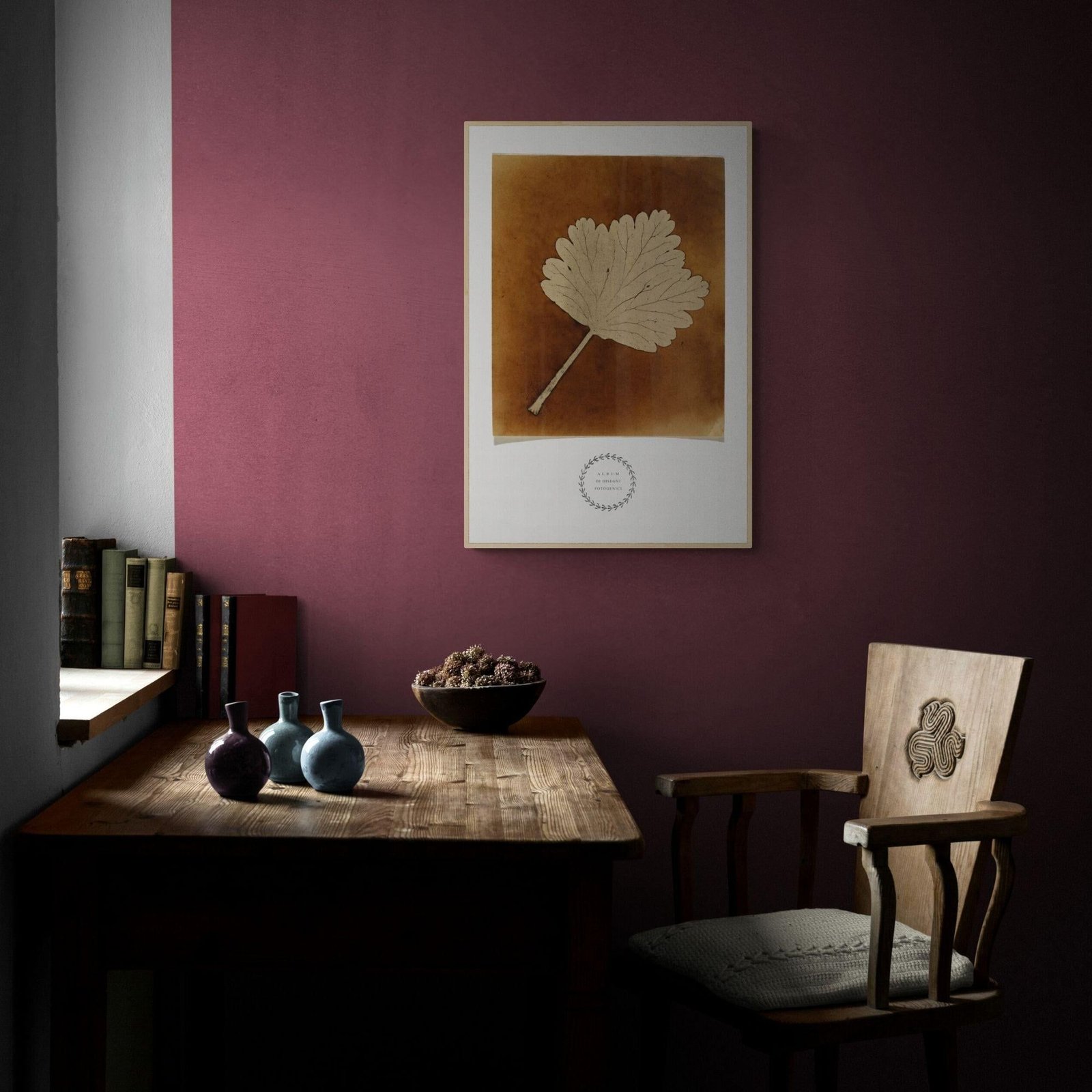 Rustic desk and chair with framed leaf print.