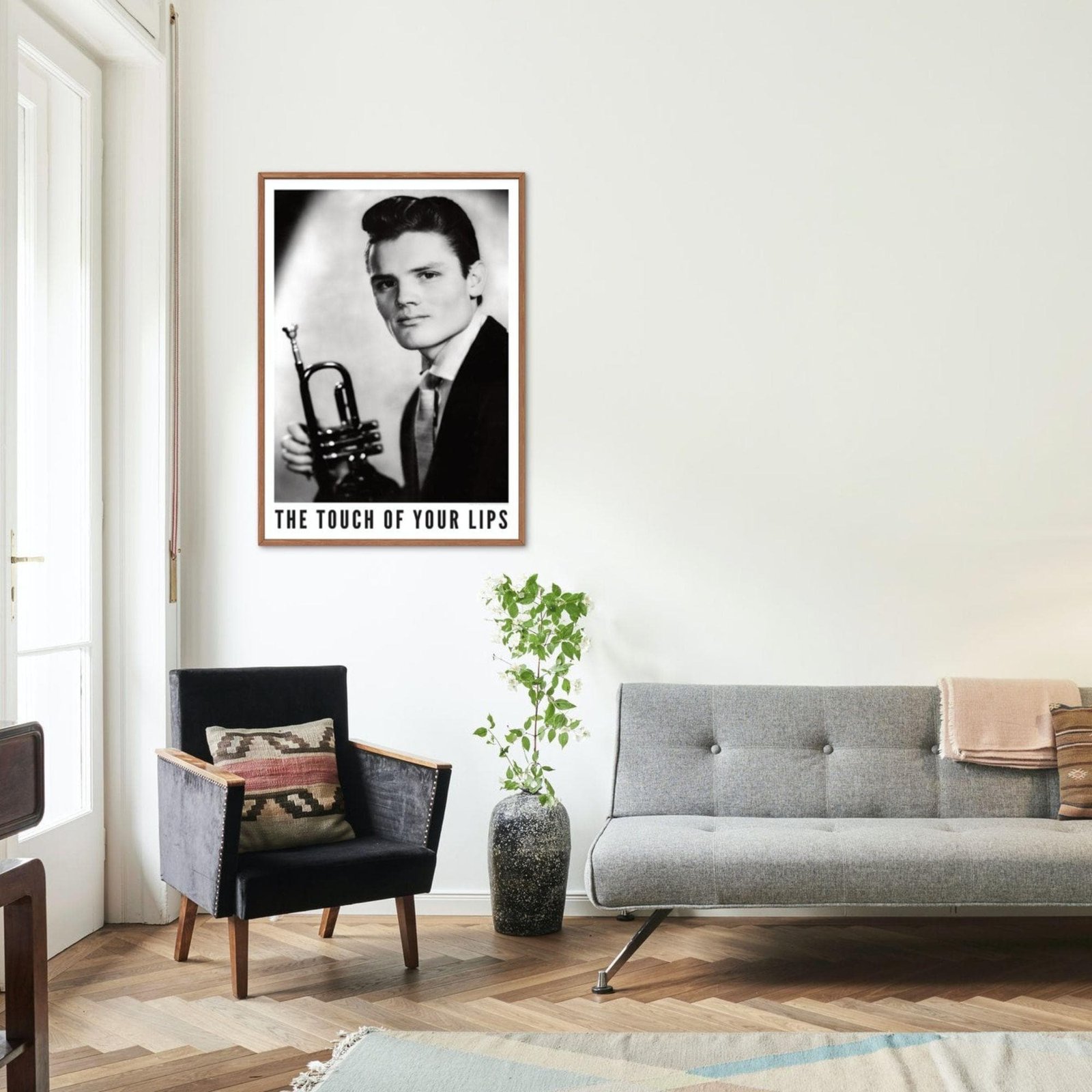 Living room with framed trumpet player photo.