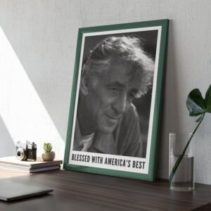Framed black-and-white portrait on wooden desk.