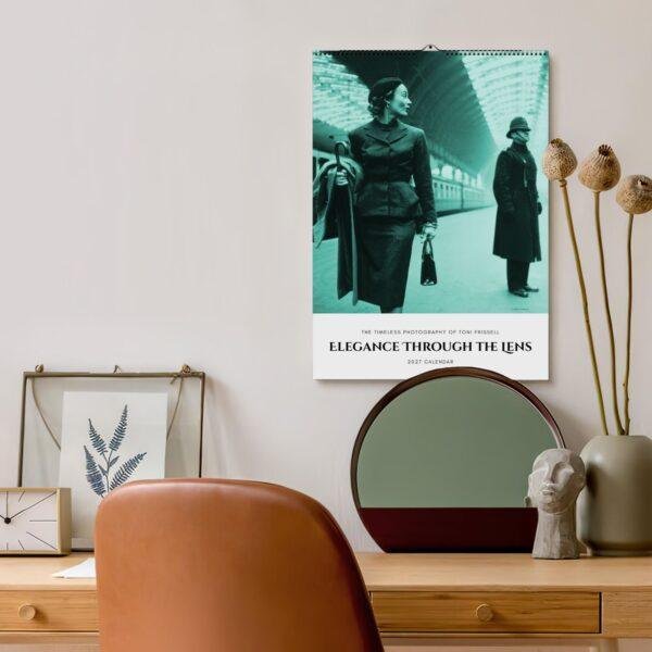 Elegant 2027 wall calendar featuring Toni Frissell photography above desk