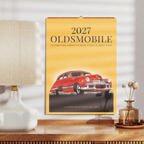 2027 Oldsmobile classic car wall calendar on wooden shelf