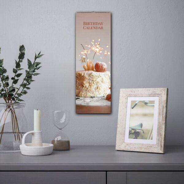 Birthday calendar with cake and sparklers hanging on wall