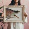 Woman holding framed vintage fish illustration art print