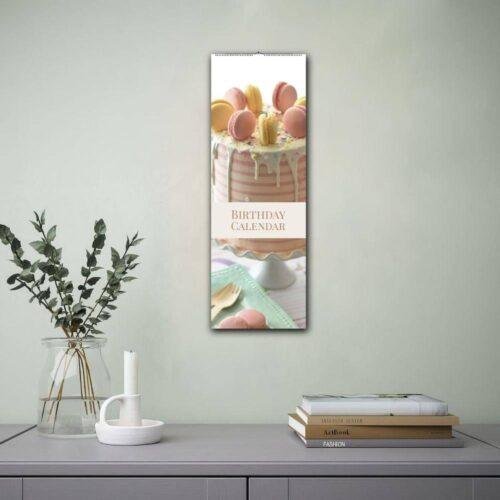Birthday calendar with macaron cake hanging on wall