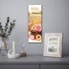 Birthday calendar with cake art hanging on gray wall