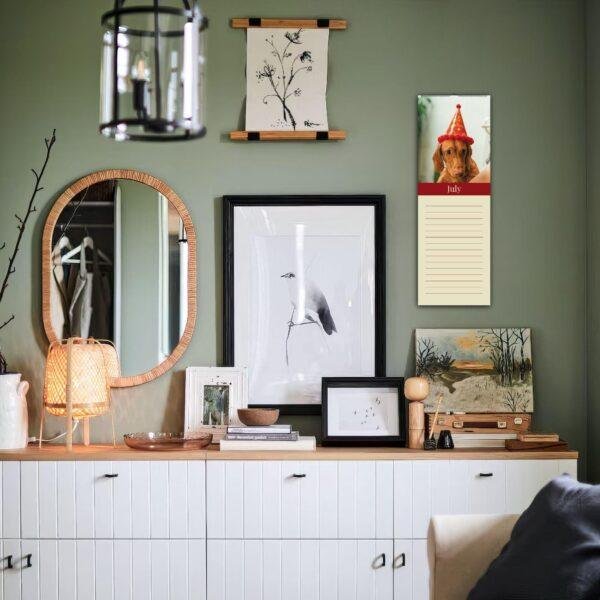 Stylish green living room with gallery wall and white sideboard