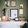 Stylish green living room with gallery wall and sideboard