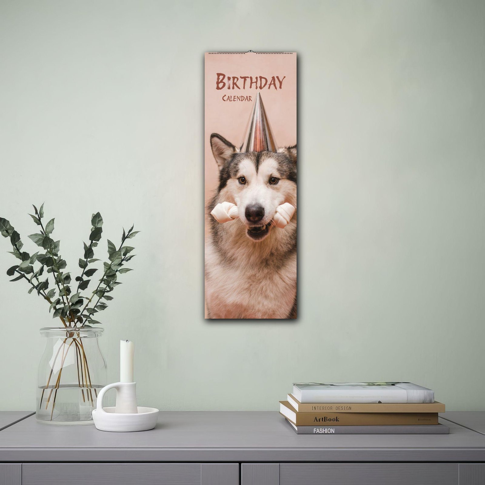 Husky dog birthday calendar hanging on green wall