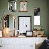 Stylish green living room with gallery wall and white sideboard