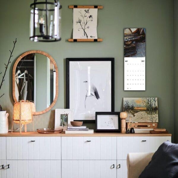 Stylish green living room with gallery wall and white sideboard