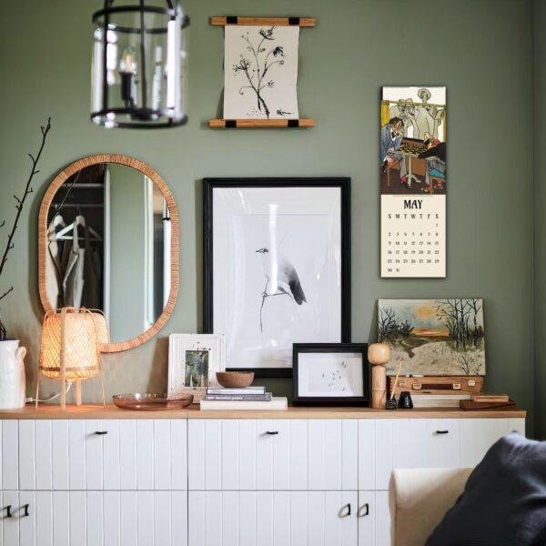 Stylish green living room with gallery wall and white sideboard