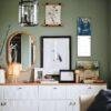 Stylish green living room with gallery wall and white sideboard