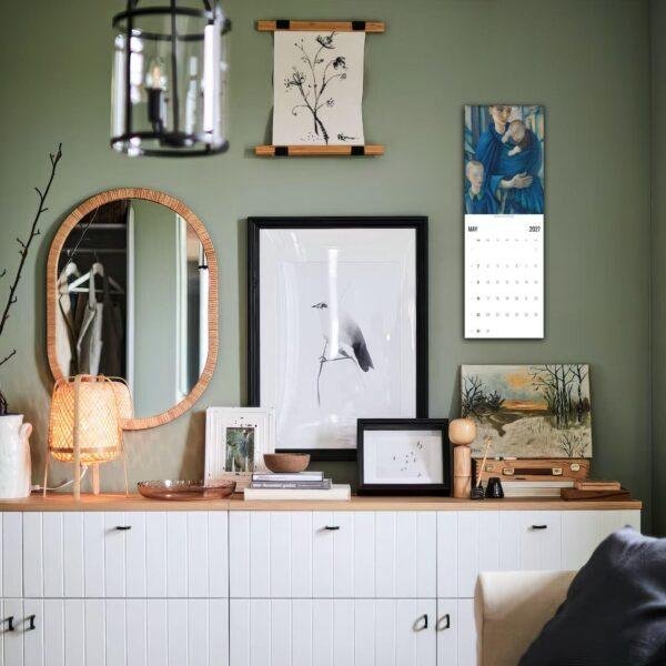 Stylish green living room with gallery wall and white sideboard