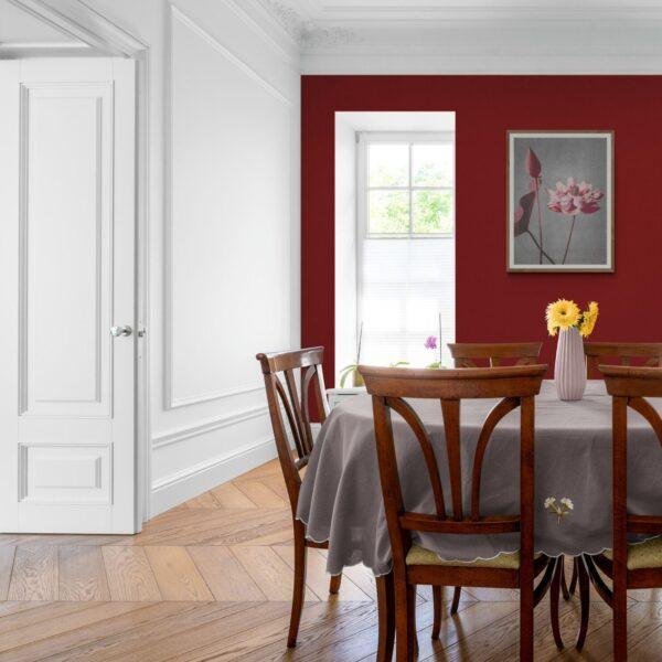 Elegant dining room with bold red accent wall and wooden furniture