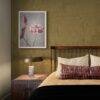 Elegant bedroom with lotus flower art above nightstand
