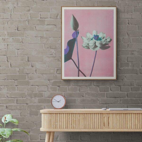 Framed lotus flower art print on brick wall above console