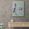 Framed lotus flower art print above modern wooden console