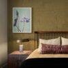Elegant bedroom with floral art print above nightstand