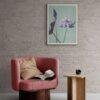 Cozy reading nook with pink armchair and floral wall art