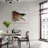 Modern dining room with bold fish artwork above round table