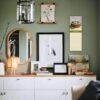 Stylish green living room with gallery wall and white dresser