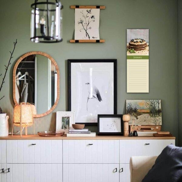 Stylish green living room with gallery wall and white dresser