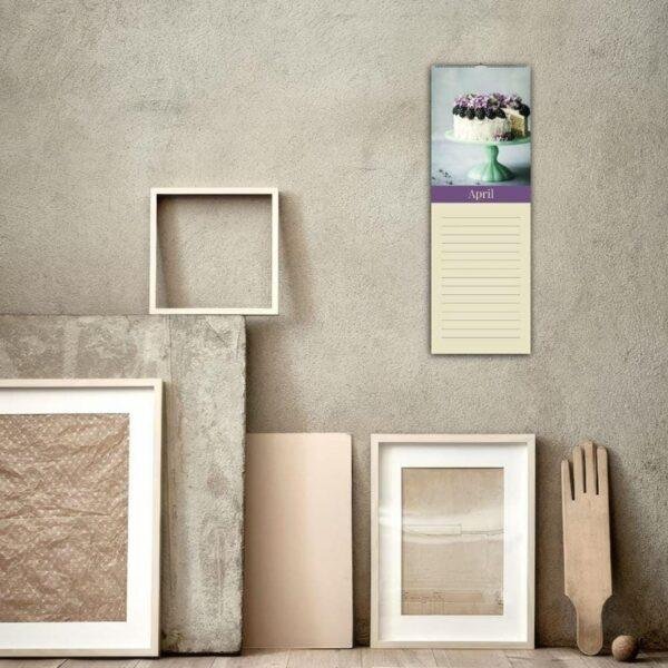 April wall calendar with cake photo above lined notepad