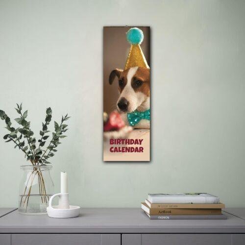Dog birthday calendar hanging on wall above desk