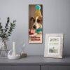 Dog birthday calendar hanging on wall above styled shelf