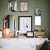 Stylish green living room with gallery wall and white sideboard