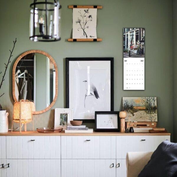 Stylish green living room with gallery wall and white sideboard